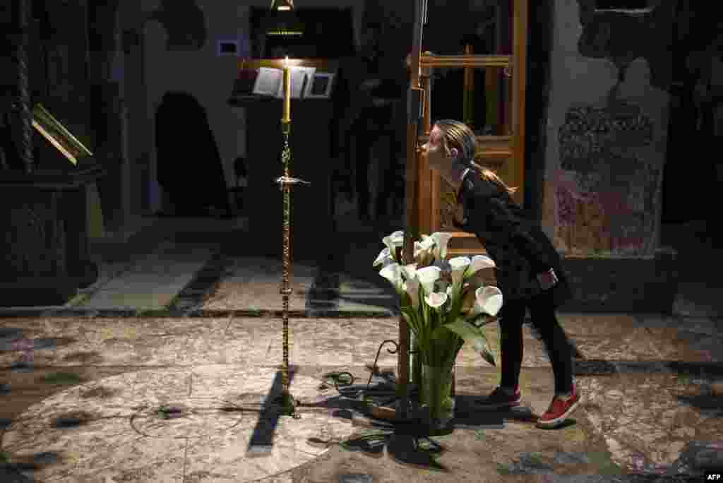 A young girl prays at the Gracanica medieval monastery in the town of Gracanica, central Kosovo. (AFP/Armend Nimani)