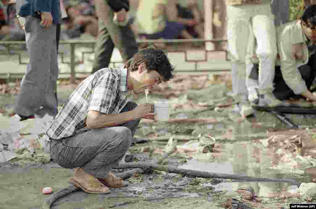 file -- Tiananmen Square Protests 1989 -- A student brushes his teeth amid the garbage in Tiananmen Square in Beijing, Friday, May 26, 1989.