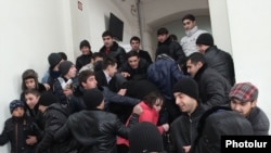 Armenia - Pro-government youths prevent journalists from covering the supposedly public defense of Yerevan Mayor Taron Markarian's doctoral thesis, Yerevan, 26Dec2013.