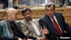 Iranian President Mahmud Ahmadinejad (center), his Afghan counterpart, Hamid Karzai (left), and Tajik President Emomali Rahmon talk during a trilateral regional summit in Tehran.