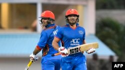 Afghan crickers Mohammad Nabi and Gulbadin Naib (R) during a recent match of Afghanistan 50 runs partnership during the 1st ODI cricket
