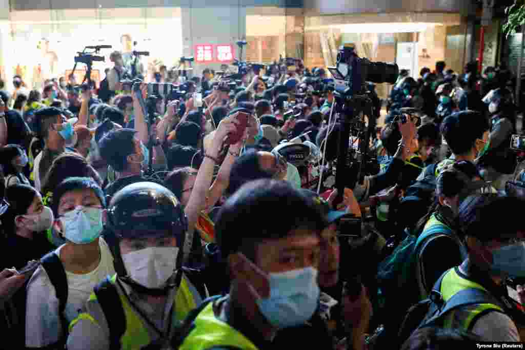 Journalist cover a march against national security law at the anniversary of Hong Kong's handover to China from Britain, in Hong Kong, China July 1, 2020. REUTERS/Tyrone Siu 