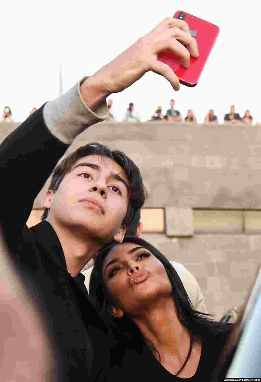 Kim puckers up for a selfie with a fan on October 8. The Kardashians were in their ancestral homeland of Armenia to baptize their children.