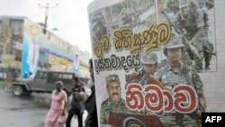 A man reads a newspaper bearing a photo of Tamil Tiger leader Velupillai Prabhakaran on the front page in Colombo on May 18.