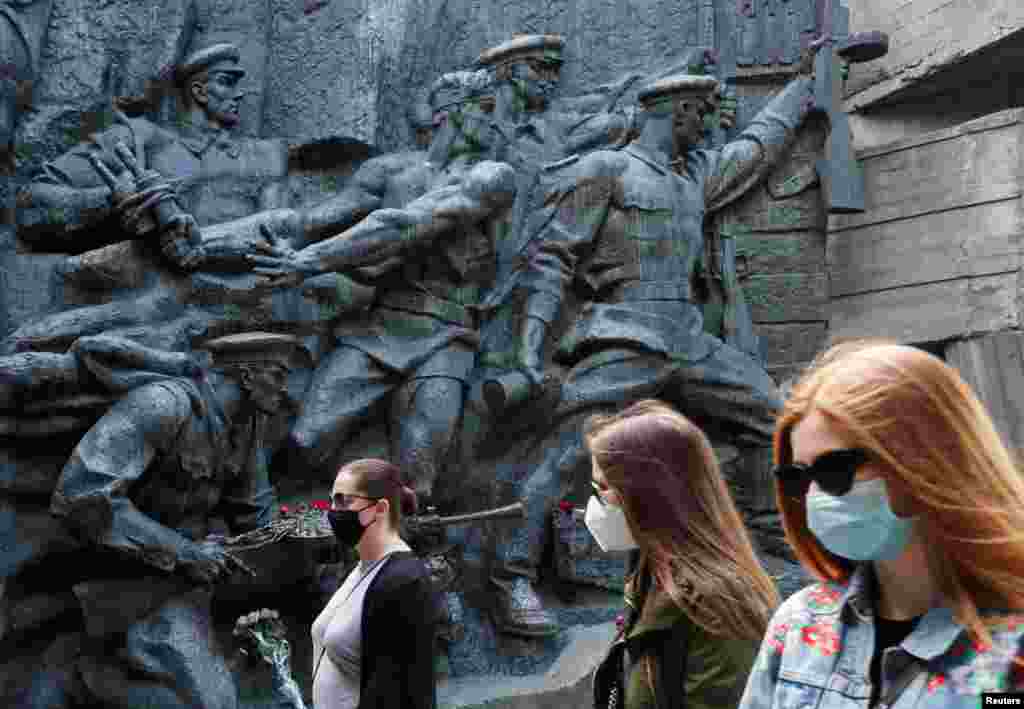Women wearing protective face masks visit the World War II museum on Victory Day, the 75th anniversary of the victory over Nazi Germany, in Kyiv on May 9. (Reuters/Valentyn Ogirenko