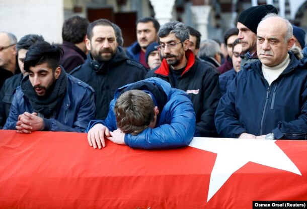 Relatives mourn at the funeral of Ayhan Arik, a victim of the Istanbul nightclub attack.