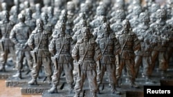Toy figures of former pro-Russian separatist commander Igor Strelkov from a collection titled "Toy Soldiers of Novorossia" are on display at a workshop in Moscow.