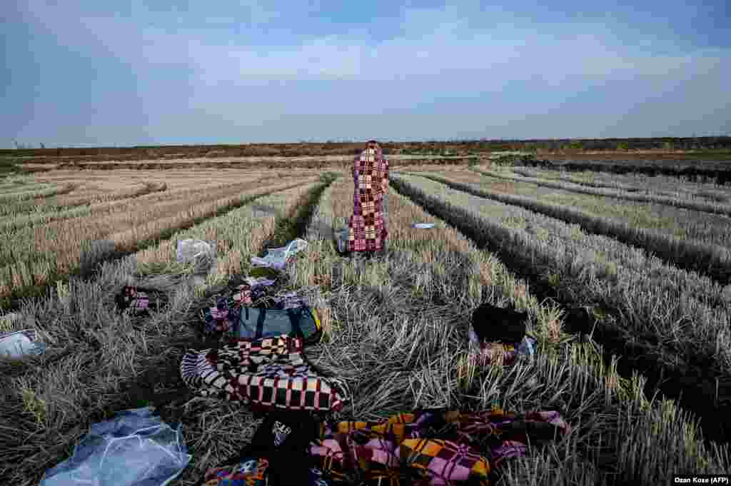 A migrant waits near the Evros River, near Edirne, in northwestern Turkey, to take a boat to attempt to enter Greece by crossing the river on March 3. (AFP/Ozan Kose)