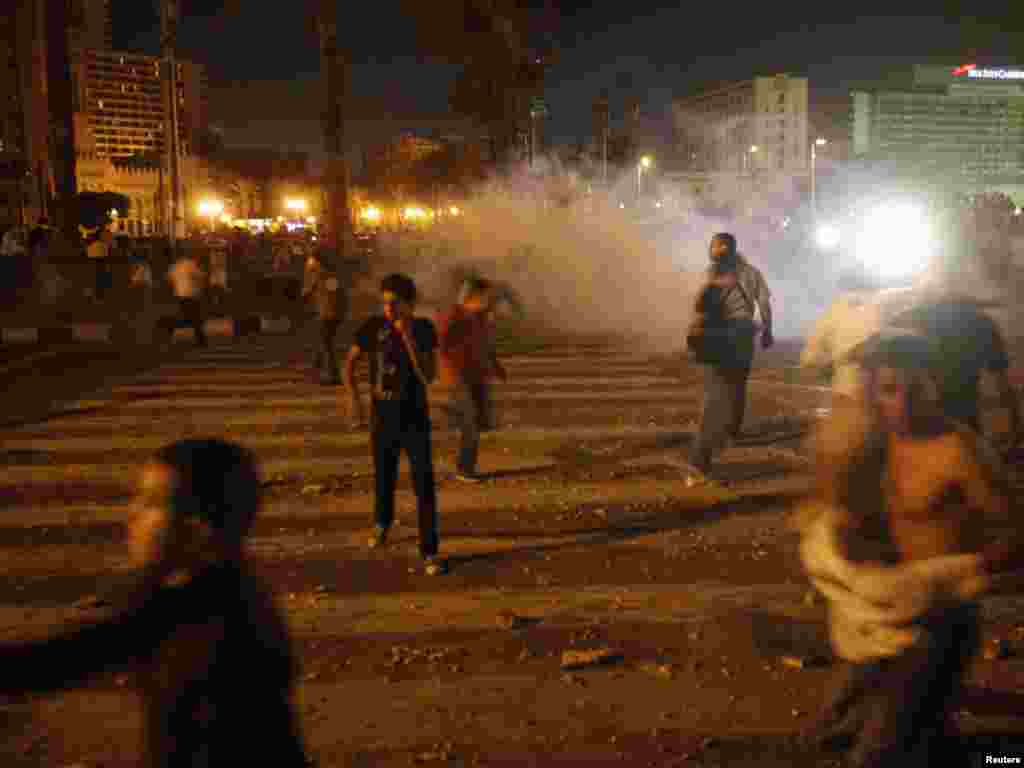 Protesters throw rocks and run away from tear gas in Tahrir Square in Cairo on June 28 in the biggest protests seen since the mass demonstrations that toppled former President Hosni Mubarak in February.Photo by Asmaa Waguih for Reuters
