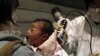 A baby who was born on March 15 is tested for possible nuclear radiation at an evacuation center in Koriayama, Japan, on March 31.