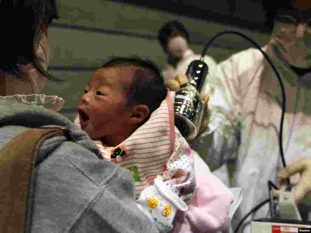 A baby born on March 15 is tested on March 31 for possible nuclear radiation at an evacuation center in Koriayama in northern Japan, about 70 kilometers from the tsunami- and earthquake-crippled Fukushima nuclear power plant. Photo by Kim Kyung-hoon for Reuters