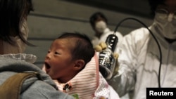 A baby who was born on March 15 is tested for possible nuclear radiation at an evacuation center in Koriayama, Japan, on March 31.