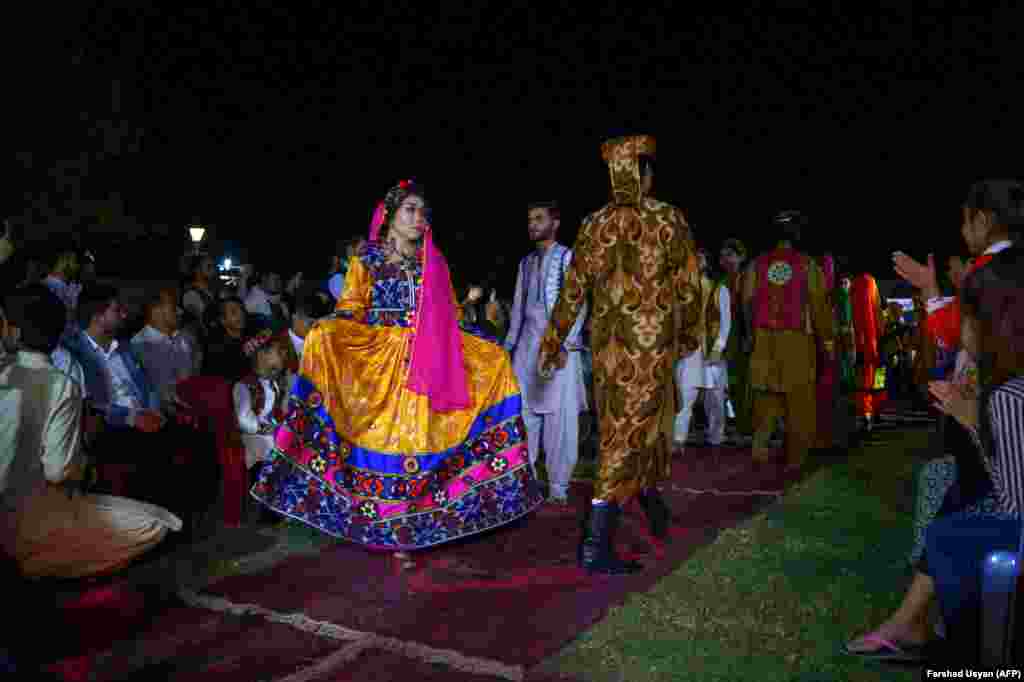 Afghan models display their outfits at the first Afghan cultural fashion show at an amusement park in Mazar-e Sharif on April 10. (AFP/Farshad Usyan)