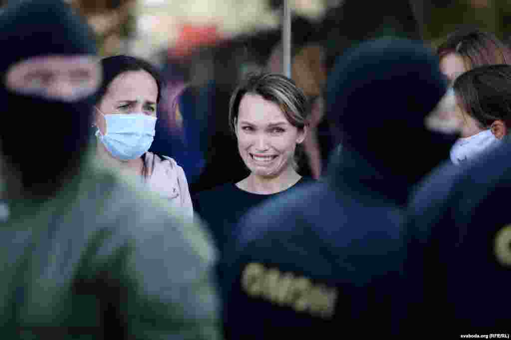 A woman reacts as she is confronted by Belarusian police during an anti-government march, mostly by women, in the Belarusian capital, Minsk, on September 19. Police detained dozens of protesters who were challenging the results of an August 9 presidential election that declared incumbent President Alyaksandr Lukashenka the landslide winner. Thousands have been detained and beaten by police, while nearly all the opposition's key leaders have been forced to leave the country or been arrested in a widening crackdown. (RFE/RL's Belarus Service)