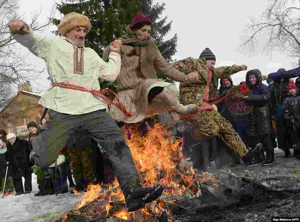 Russians leap over a bonfire during Maslenitsa celebrations near St. Petersburg on February 25. The festival pre-dates Christianity and marks the imminent end of winter.&nbsp;