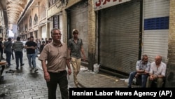People walk through the old grand bazaar where shops are closed after a protest, in Tehran, Iran, Monday, June 25, 2018. File.