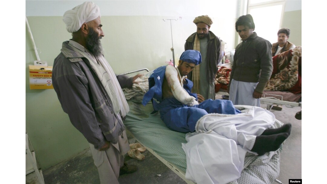 An Afghan man receives treatment in a Herat hospital after he was wounded in a suicide bombing in Farah Province in April.