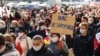 Pensioners and students protest in Minsk on October 26, 2020, carrying a sign reading, "You can't frighten us."