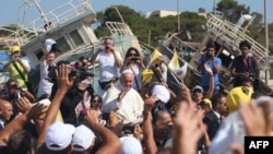 Pope Francis waves to migrants upon a visit to the Italian island of Lampedusa earlier this year. 