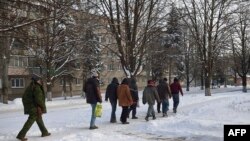 Ukrainian prisoners of war under the supervision of a rebel guard, walk in a street in the eastern city of Ilovaisk, controlled by pro-Russian rebels. Despite today's prisoner swap, rebels are believed to be holding around 500 more government soldiers in captivity. 