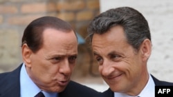 Italian Prime Minister Silvio Berlusconi (left) greets French President Nicolas Sarkozy prior to their summit in Rome.