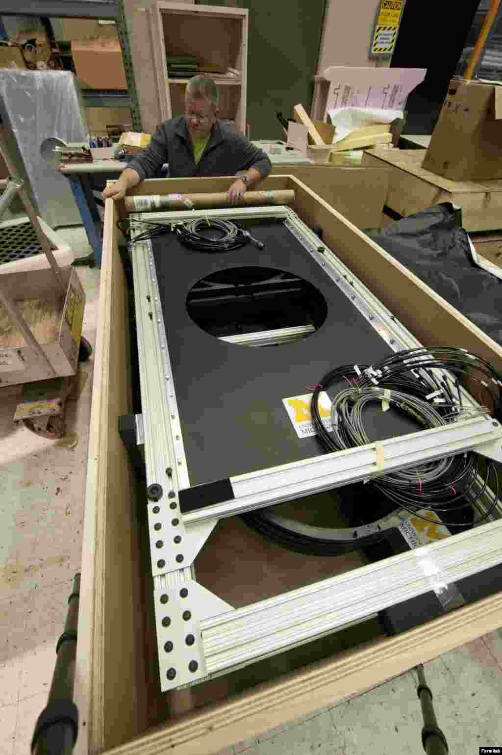 The Dark Energy Camera will have the world&rsquo;s largest camera filter, seen here being unpacked at Fermilab for assembly onto the camera.