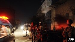 Pakistani paramilitary soldiers cordon off the site of an attack on a Karachi market on October 19.