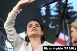 Svyatlana Tsikhanouskaya waves to the crowd at the Minsk rally.