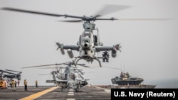 Helicopters take off aboard the amphibious assault ship USS Boxer as it transits the Strait of Hormuz in 2019.