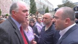 Armenia -- Gloria factory owner Bagrat Darbinian (L) argues with a police officer, Vanadzor, April 21, 2020.