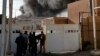 Iraqi security forces secure the site of a fire that broke out at Baghdad's largest ballot-box storage site, where ballots from Iraq's May parliamentary elections were stored, in Baghdad on June 10.