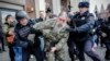 Russian riot police detain an opposition activist during a protest rally in central Moscow on November 5.