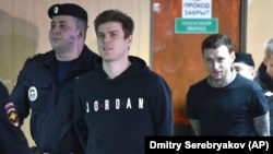 Zenit St. Petersburg striker Aleksandr Kokorin (2nd left) and Krasnodar midfielder Pavel Mamayev arrive for a hearing in Moscow on April 3.