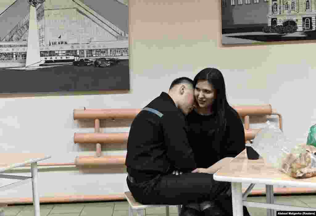 An inmate meets with a loved one on the Open Doors Day marking the New Year and Christmas season at a high-security penal colony in Omsk, Russia. (Reuters/Alexey Malgavko)