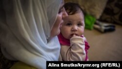 Муміне Салієва тримає на руках молодшу доньку – Сафію