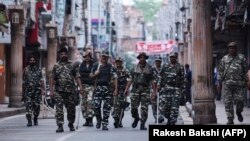 Security personnel patrol a street in Jammu on August 6.