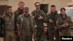 Syrian Democratic Forces fighters pose near Raqqa. (file photo)
