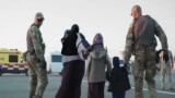 file 2019 -- KAZAKHSTAN -- Kazakhstan repatriated its citizens from Syria, Kazakh military officers carrying a family during Zhusan / Jusan humanitarian operation in 2019.