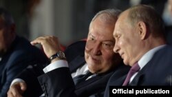 Belarus - Presidents Armen Sarkissian (L) of Armenia and Vladimir Putin of Russia attend the opening ceremony of the European Games in Minsk, June 20, 2019.