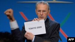 IOC President Jacques Rogge shows the card reading "Tokyo" as he announces the winner of the bid to host the 2020 Summer Olympic Games.