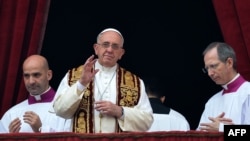 Pope Francis (center) gives his traditional Christmas "Urbi et Orbi" blessing from the balcony of St. Peter's Basilica at the Vatican on December 25.