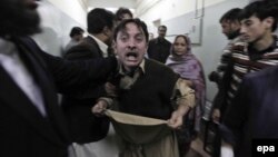 A relative of one of the victims of the attack reacts at a local hospital in Peshawar on February 13.