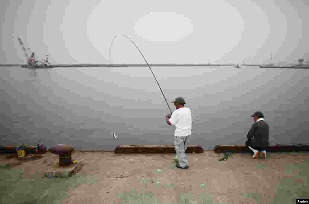 Local residents fish in Iwaki, about 40 kilometers south of the nuclear power plant.