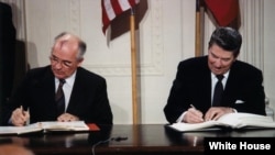 Mihail Gorbaciov și Ronald Reagan semnând Tratatul Forțelor Nucleare cu Rază Medie, Casa Albă, 8 decembrie 1987.