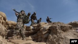 Afghan National Army soldiers walk through Dand-e-Ghori district in Baghlan Province on March 15.