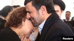 Iranian President Mahmud Ahmadinejad offers his condolences to Elena Frias, mother of Venezuela's late President Hugo Chavez, during the funeral service at the Military Academy in Caracas on March 8. The photo was released to the media by the press office of the Venezuelan presidency.