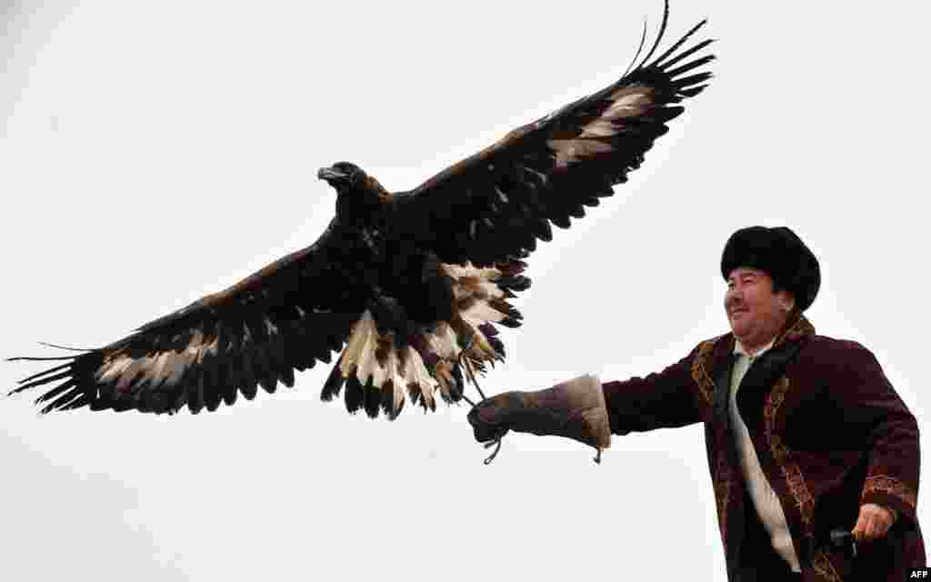 A Kyrgyz hunter flies a golden eagle during a hunting festival in the village of Cholpon-Ata.