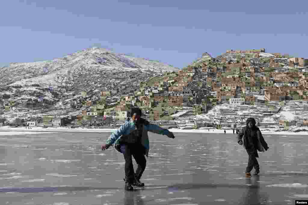 Afghan children play on a frozen lake in Kabul. (Reuters/Omar Sobhani)