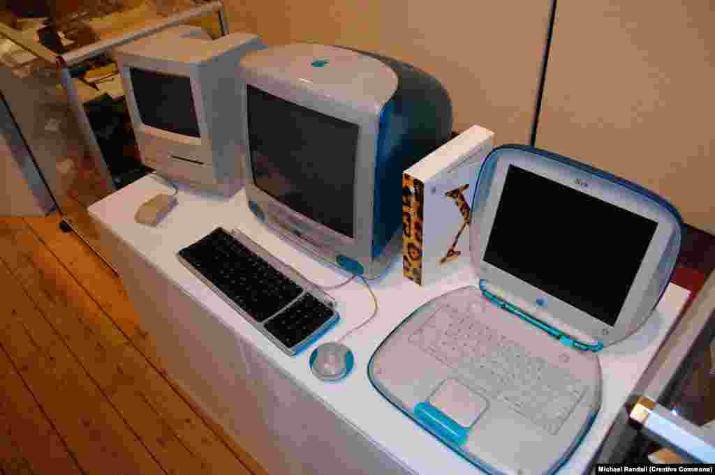 A Mac Classic sits next to the later and more colorful iMac and iBook.