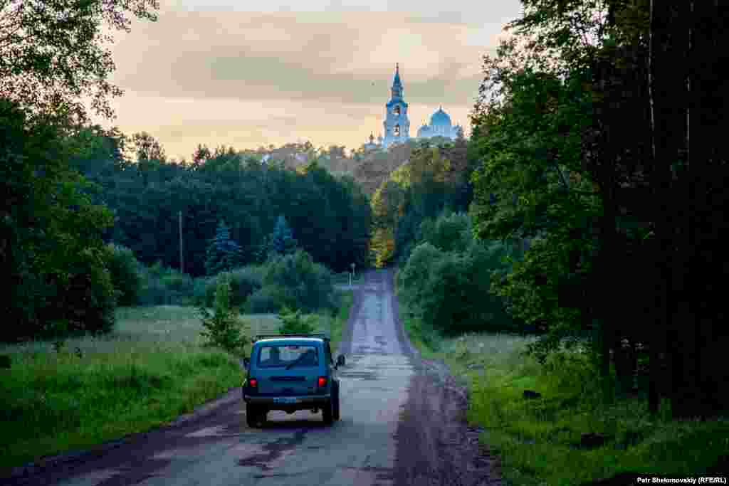 A Soviet-made Niva car drives toward the Valaam Monastery.